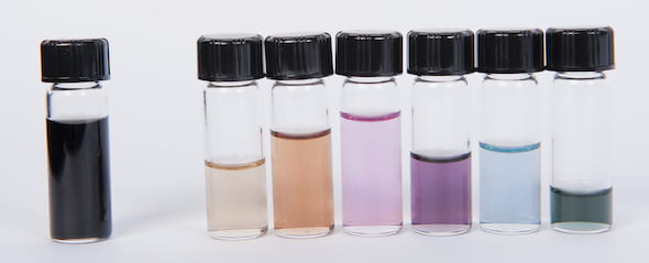 Armchair-enriched batches of nanotubes show their colors in an array of varying types. The vial at left is a mix of nanotubes straight from the furnace, suspended in liquid. The vials at right show nanotubes after separation through ultracentrifugation. Excitons absorb light in particular frequencies that depend on the diameter of the tube; the mix of colors not absorbed are what the eye sees. (Credit: Erik Hároz/Rice University)