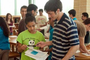 Rice students speak Spanish with local eighth-graders.