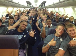Rice players on a plane headed back to Houston after beating Kansas