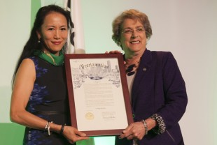 University Representative Y. Ping Sun (left) receives the mayor's proclamation from Houston City Council member Ellen Cohen.
