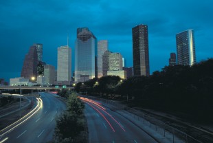 Downtown Houston at night overlooking highway.