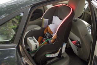The Infant SOS device installed in a car with visual alerts flashing.