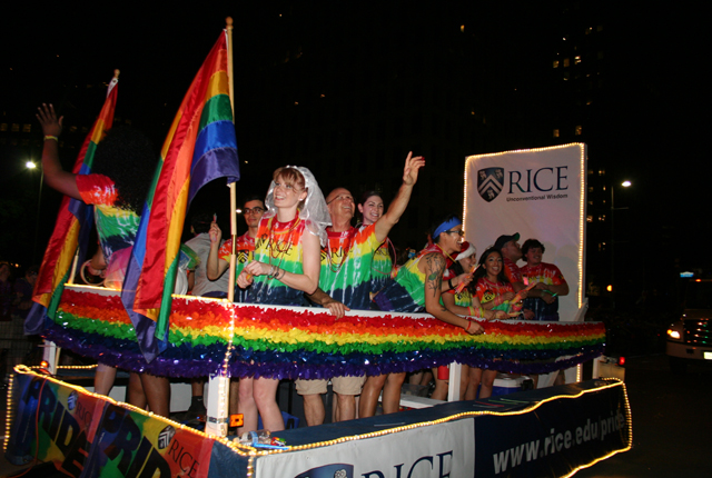 Students wear tie-dyed T-shirts on Rice's float in the pride parade.