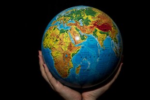 image of globe held in two hands