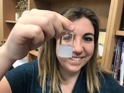 Rice University graduate student Ashleigh Smith McWilliams holds a vial of boron nitride nanotubes in solution. McWilliams led a Rice effort to find the best way to separate the naturally clumping nanotubes to make them more useful for manufacturing. The nanotubes turn the clear liquid surfactant white when they are dispersed. 