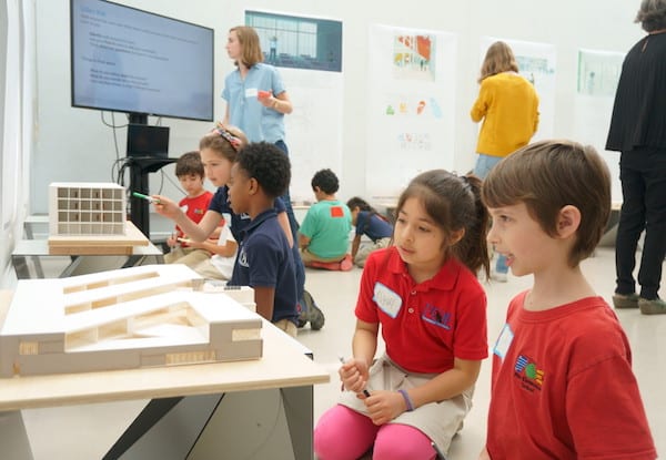 Poe Elementary students view a model of an elementary school by graduate students at the Rice School of Architecture during a recent visit.