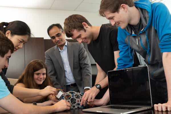 Members of the Axon Mobile team of Rice University engineering students gather with their adviser, Dr. Nitin Tandon, to discuss progress on their wireless monitor to record seizure data from patients with intractable epilepsy. From left: Andres Gomez, Irene Zhang, Sophia D'Amico, Tandon, Benjamin Klimko, and Aidan Curtis. (Credit: Jeff Fitlow/Rice University)