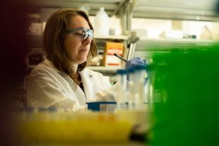 Kathryn Brink working at a lab bench