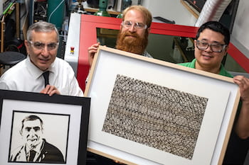 Imaging with laser-induced graphene (LIG) was taken to a new level in a Rice University lab. From left, chemist James Tour, holding a portrait of himself in LIG; artist Joseph Cohen, holding his work "Where Do I Stand?"; and Yieu Chyan, a Rice graduate student and lead author of a new paper detailing the process used to create the art. (Credit: Jeff Fitlow/Rice University)