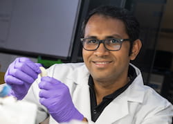 Rice University research scientist M.M. Rahman holds a flexible dielectric made of a polymer nanofiber layer and boron nitride. The new material stands up to high temperatures and could be ideal for flexible electronics, energy storage and electric devices where heat is a factor. (Credit: Jeff Fitlow/Rice University)