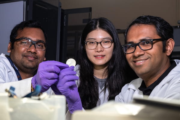 From left, postdoctoral researcher Anand Puthirath, academic visitor Fanshu Yuan and research scientist M.M. Rahman show the high-temperature flexible dielectric material invented at Rice University. The three are among authors of a paper in Advanced Functional Materials that details the work. (Credit: Jeff Fitlow/Rice University)