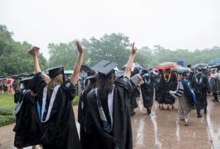 A little rain didn't dampen the spirits of the newly minted graduates as they made their ceremonial exit through the Sallyport. Photo by Tommy LaVergne. 