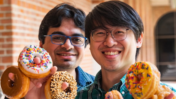 Rice University graduate students Nitant Gupta, left, and Henry Yu performed theoretical calculations that showed how the "donuts" on a growth substrate influence the electronic behavior of two-dimensional materials. The resulting localized strain could help researchers tune the properties of the material for applications like quantum information systems. (Credit: Jeff Fitlow/Rice University)