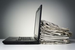 Laptop and newspaper concept for internet and electronic online news