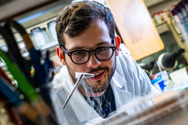 Rice University graduate student Ian Campbell pulls a vial of ferredoxin proteins from cold storage. The iron and sulfur proteins, believed to be present at the start of life on Earth, facilitate the transfer of energy in cells. The Rice experiments showed synthetic biologists may use them to control electron transfer in cells.