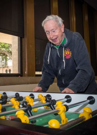 Doc C enjoying a game of foosball at Will Rice College. Photo by Tommy LaVergne.