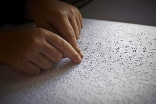 A child reads braille. Photo credit: 123rf.com
