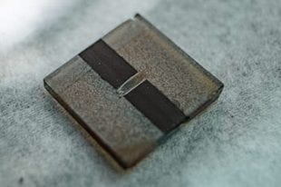 A sample all-inorganic perovskite solar cell is a step toward commercial use, according to scientists at Rice University. Their discovery of a way to quench defects in cesium-lead-iodide solar cells allowed them to preserve the material’s band gap, a critical property in solar cell efficiency. (Credit: Jeff Fitlow/Rice University)