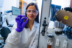 Rice University research scientist Maryam Elizondo holds an engraved bioscaffold 3D-printed for live cells for future implantation. The scaffold encourages the growth of layered tissues as it degrades. (Credit: Jeff Fitlow/Rice University)
