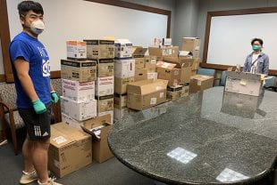 Graduate students Yuren Feng and Xiaochuan Huang with boxes of masks, gloves and other protective gear and lab testing supplies that Rice laboratories donated to the University of Texas Health Science Center at Houston April 1.