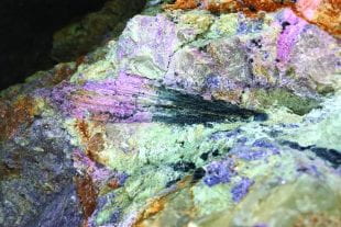 Black tourmaline going to pink tourmaline within a quartz pegmatite at California's Stewart Lithia mine.