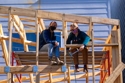 Rice Architecture students Alex Oetzel, left, and Claire Wagner work on framing of the Auxiliary ADU under construction in Houston’s First Ward. The small house will be energy-independent, with solar panels and a breezeway that separates two living spaces. (Credit: Brandon Martin/Rice University)