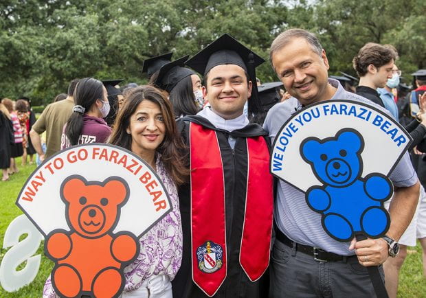 Faraz Virani '21 was among those whose parents had made custom signs to greet their graduates. (Photo by Tommy LaVergne)