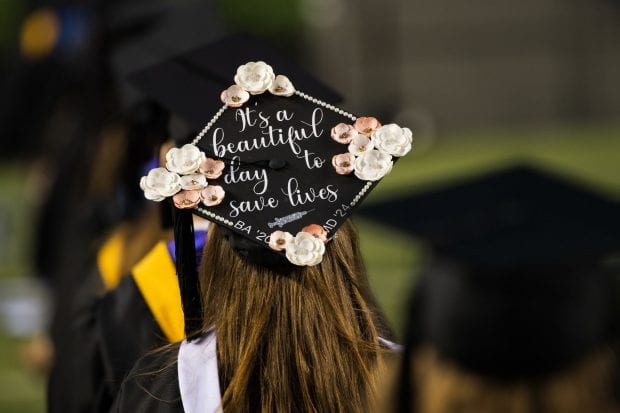 A Rice student's decorated Class of 2020 mortarboard says "It's a beautiful day to save lives."