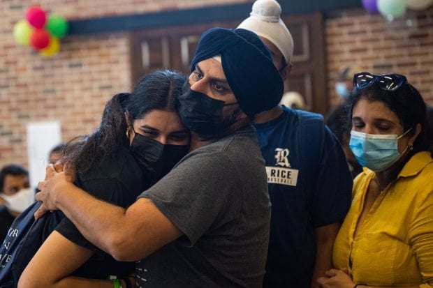 Families hug goodbye at the end of an emotional move-in morning. (Photo by Jeff Fitlow)